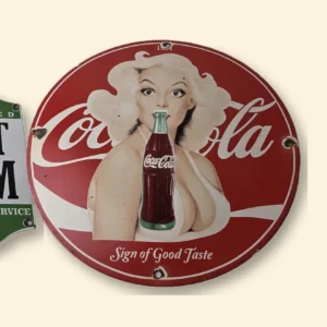 Coca-Cola, Texaco Rest Room and Shell Free Air porcelain signs showing the glossy fired enamel that sets porcelain vs tin signs apart