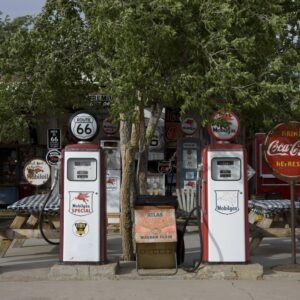 Color photo of vintage gas pumps, a Route 66 shield and a Coca-Cola sign outside the Hackberry General Store in Arizona